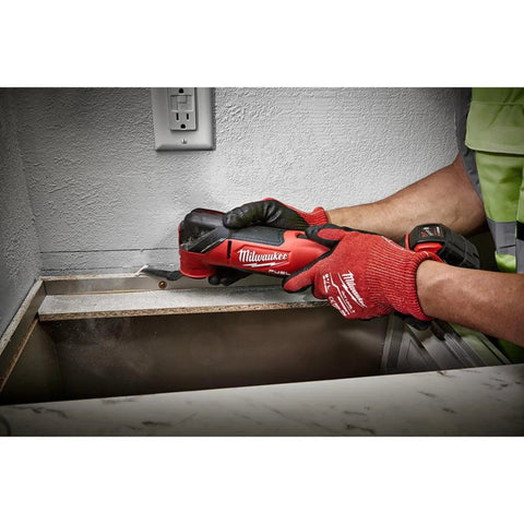 Close-up of M18 FUEL Oscillating Multi Tool Kit With Brushless Power And Beast Mode Speed Quick Change Accessories cutting drywall