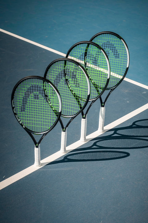 Four IG Speed Jr 26 Inch Junior Tennis Racquets For Youth Ages 9 11 with ultra lightweight graphite composite frame on court.