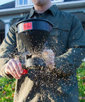 Person using Five Pound All Season Handheld Spreader With Easy Fill Design For Seed Ice Melt And Fertilizer Perfect For Sidewalks Yards