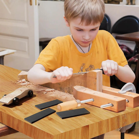 Child using tools with Derby Car Pinewood Weights Kit With 3 Oz Stick On Flexible Weights And Half Ounce Graphite Lubricant nearby
