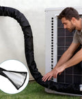 Man installing Three Layer AC Pipe Insulation Cover With Flexible Split Foam Wrap Sleeve For Central AC And Mini Split Lines outside unit
