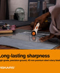 Person using 45mm Rotary Cutter For Fabric, Cuts Through Multiple Layers, Left Or Right Handed, Easy Safe Blade Change, on fabric