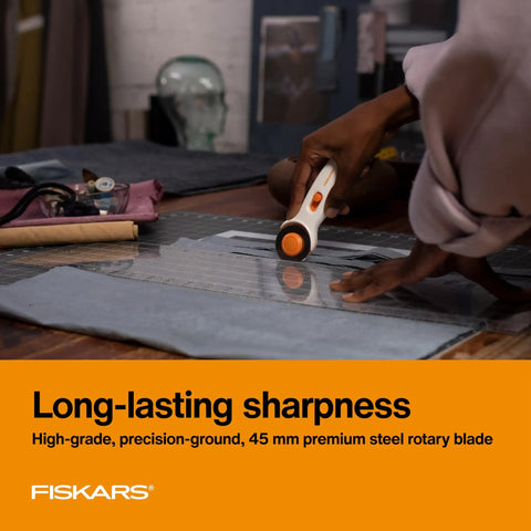 Person using 45mm Rotary Cutter For Fabric, Cuts Through Multiple Layers, Left Or Right Handed, Easy Safe Blade Change, on fabric