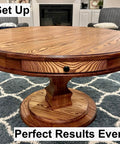 Wooden round table with visible wood grain finish on a patterned rug in a living room.