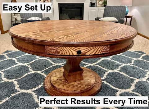 Wooden round table with visible wood grain finish on a patterned rug in a living room.