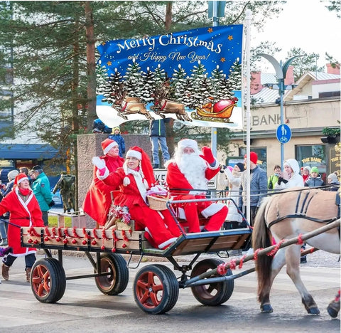 Christmas parade scene with multiple Santas on a horse-drawn carriage in a festive street, displaying a 'Merry Christmas' banner.