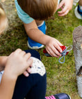 Kids using Kids Pocket Knife Toy 4.4 Inch VX Red Swiss Army Style Pretend Tool for Young Adventurers Safe Build on tree stump