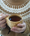 Person holding Nordic Style Kuksa Wood Camp Mug 10 Oz Handcrafted Carved Hardwood Outdoor Cup for Camping Backyard Chill Family Trips