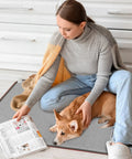 110V Heated Floor Mat Foot Warmer Under Desk 31.5 By 20 Inch Electric Heating Pad with person and dog in living room