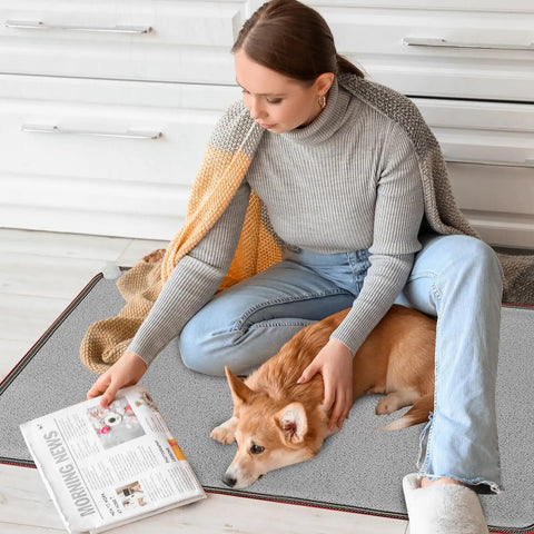 110V Heated Floor Mat Foot Warmer Under Desk 31.5 By 20 Inch Electric Heating Pad with person and dog in living room