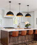 Esfos 11.8" Black and Gold Pendant Lights Kitchen Island, 3 Pack Chandelier over a modern kitchen island with brown stools.