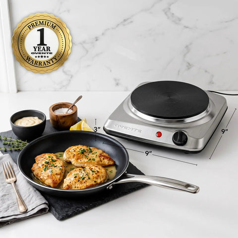 Electric Countertop Single Burner Cooktop 1000W With 7.25 Inch Cast Iron Plate beside a pan with cooked chicken on a counter.