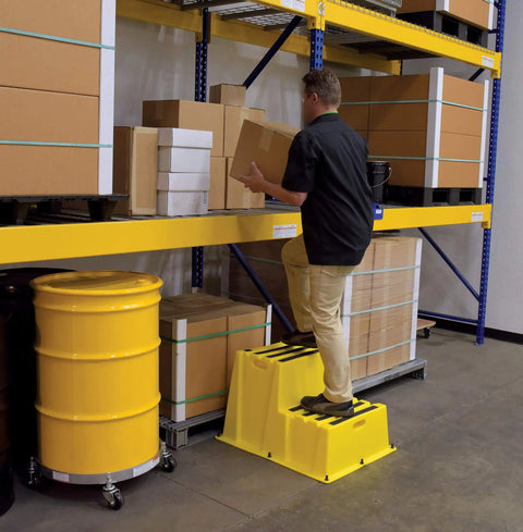Man using Nestable Polyethylene 2 Step Stool With 500 Lb Capacity, Yellow, Anti Slip Treads, Lightweight And Portable With Front And Side Handles