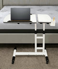 Smooth Rolling Standing Desk Heavy Duty Sit Stand Laptop Cart Adjustable Height with lockable wheels beside a bed.