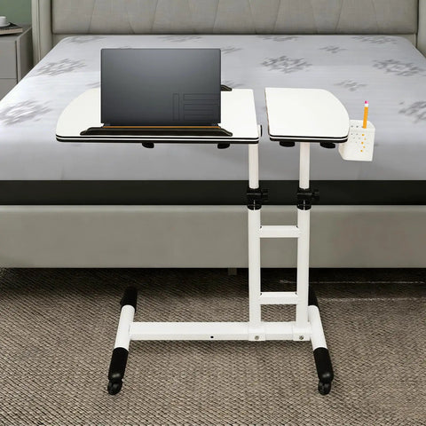 Smooth Rolling Standing Desk Heavy Duty Sit Stand Laptop Cart Adjustable Height with lockable wheels beside a bed.