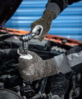 Person wearing Level 5 Cut Resistant Work Gloves For Gardening And Tough Jobs, Aramid And HPPE Safety Gloves With Cow Split Leather, Size Large, using a wrench in a car engine.