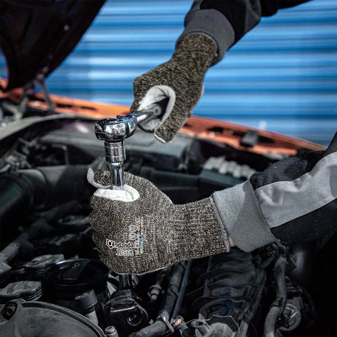Person wearing Level 5 Cut Resistant Work Gloves For Gardening And Tough Jobs, Aramid And HPPE Safety Gloves With Cow Split Leather, Size Large, using a wrench in a car engine.