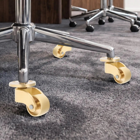Heavy Duty Swivel Casters Four Pack Brass Furniture Wheels Silent Roll Protects Hardwood Floors Built Tough For Tables And Chairs Smooth Glide Rolling Hardware installed on a chair base.