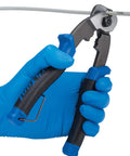 Pro Cable And Housing Cutter With Built In Crimper cutting a bike cable, showing cold forged steel handles and precision ground jaws.