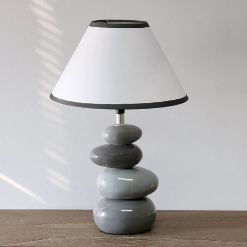 Shades Of Gray Ceramic Stacked Stone Table Lamp With Fabric Shade, 14.7 Inch Modern Bedside Light on wooden surface.