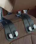 Sleek Double Purse Hook For Car, Universal Auto Seat Back Hanger, Premium Stitched Leather And Alloy Bag Organizer attached to car headrest.