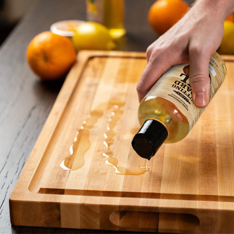 Fractionated Coconut Oil Cutting Board Oil For Kitchen Counters, Butcher Blocks, Wooden Bowls And Utensils, Food Safe, Deep Wood Nourishment being poured onto a wooden cutting board