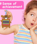 Child holding completed project from Beginner Needlepoint Cross Stitch Kit For Kids Ages Five To Eight, with bear pattern.