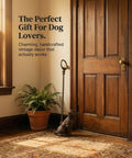Sturdy Cast Iron Dog Door Stopper With Handle For Easy Moving at door with plant, perfect for dog lovers' home decor.