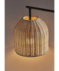 Close-up of rattan shade on Bahama Table Lamp With Dark Bronze Finish For Warm Coastal Modern Vibes, illuminated and glowing.