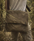 Person wearing XL Haversack Foraging Bag Waxed Canvas Bushcraft Messenger With Reinforced Straps Durable Vintage Look outdoors
