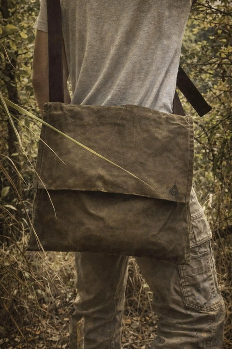 Person wearing XL Haversack Foraging Bag Waxed Canvas Bushcraft Messenger With Reinforced Straps Durable Vintage Look outdoors