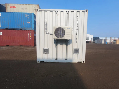 No Worries 10 Inch Gravity Damper Intake Louvered Vents For Storage Sheds And Goat Barns, 2 Pack mounted on a white shipping container with air conditioning unit.