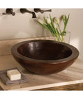 Premium Slick Vessel Bathroom Sink Made From Tough 16 Gauge Hammered Copper With An Antique Bronze Finish on countertop.