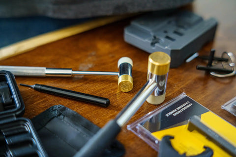 Close-up of Roll Pin Install Tool Kit with Trigger Install Tool Punch Set Brass and Polymer Hammer on Workbench