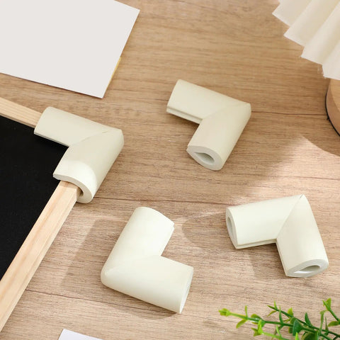 White Foam Corner Protectors 12-Piece U-Shaped Edge Guards for Furniture and Photo Frames on wood surface