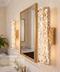 AooLiWang Gold LED Wall Sconces, Set of 2 with Transparent Glass Strip, modern bathroom sconces beside a mirror.