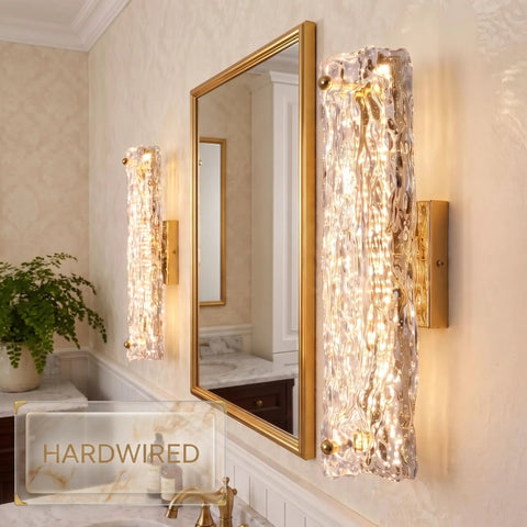 AooLiWang Gold LED Wall Sconces, Set of 2 with Transparent Glass Strip, modern bathroom sconces beside a mirror.