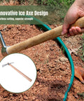 Person using Stainless Steel Garden Pickaxe Handheld Mattock for gardening tasks on soil, showing wooden handle and stainless steel head.
