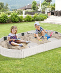 Kids playing in white elliptical Kids Sandbox With Cover And Built In Seating, Weather Resistant Outdoor Sand Pit For Backyard Fun