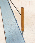 Badass Marking Knife Set High Carbon Steel Blades With Double Bevel Edges And Ergonomic Grip Handle on wood backdrop next to a saw.