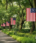 Patriotic Garden Flag Celebrating 250 Years Of America With Double Sided USA Flag for Yard along a tree-lined path showcasing its design.