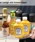 Person holding Large 13 Inch Lazy Susan Cabinet Organizer Two Pack Non Slip Clear Turntable Storage Tray with condiments
