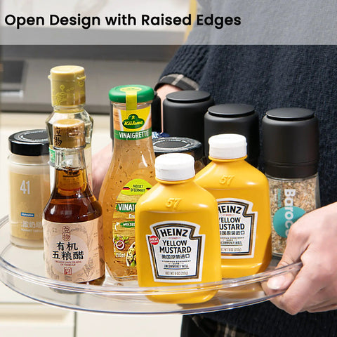 Person holding Large 13 Inch Lazy Susan Cabinet Organizer Two Pack Non Slip Clear Turntable Storage Tray with condiments