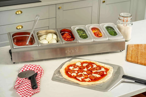 Pizza Topping Station Kit With 2 x 1.6L And 4 x 0.8L Containers, Custom Fit Lids, on a kitchen counter with pizza ingredients