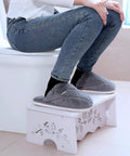 Person using 7 Inch Squat Toilet Stool For Bathroom Made From Wood Plastic Composite, Boost Posture, with elegant hollow carved design