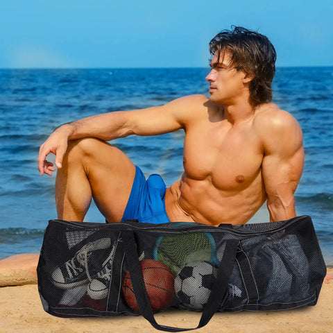 Man at beach with Two Pack Large Mesh Dive Bags 37 By 15 By 15 Inches For Diving Snorkeling Beach Travel Gear Storage