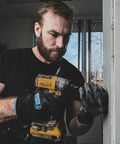 Man using drill while wearing Never Slip Maximum Grip All Purpose Work Gloves For Men With Polymer Palm For Wet Dry And Oily Conditions