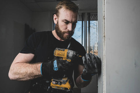 Man using drill while wearing Never Slip Maximum Grip All Purpose Work Gloves For Men With Polymer Palm For Wet Dry And Oily Conditions