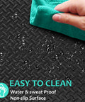 Close-up of a black puzzle mat showing water droplets being wiped, labeled as easy to clean. Interlocking 12 Tile Exercise Mat Set For Your Home Gym Setup With 24 By 24 Inch EVA Foam Flooring Puzzle Mats For Safe Workout Area And Equipment Protection Black.