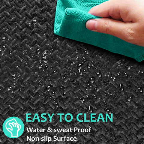 Close-up of a black puzzle mat showing water droplets being wiped, labeled as easy to clean. Interlocking 12 Tile Exercise Mat Set For Your Home Gym Setup With 24 By 24 Inch EVA Foam Flooring Puzzle Mats For Safe Workout Area And Equipment Protection Black.